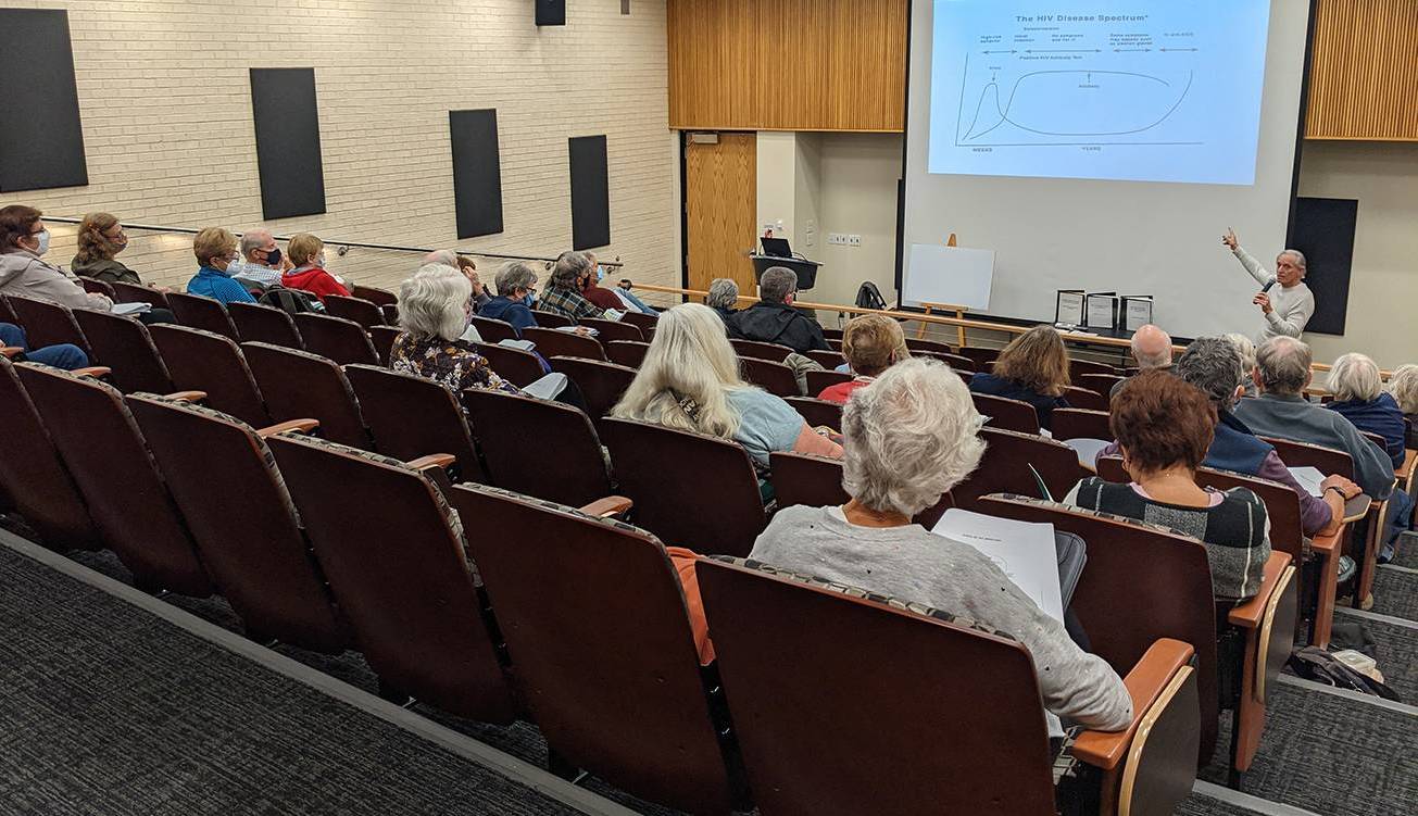 MVILR lecture People listening to person giving presentation in auditorium