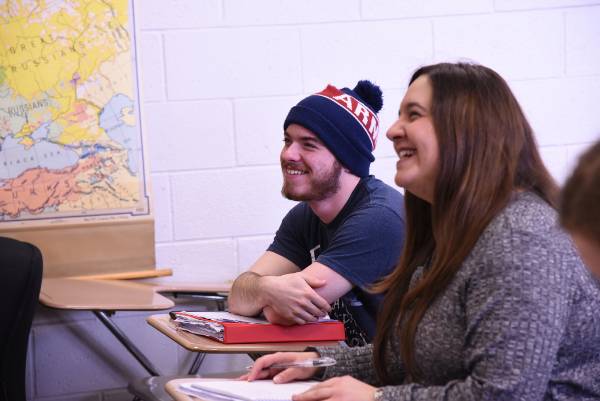 Childhood Education Two students sitting in class, smiling