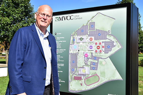 Alumnus Christopher Crolius standing in front of MVCC sign