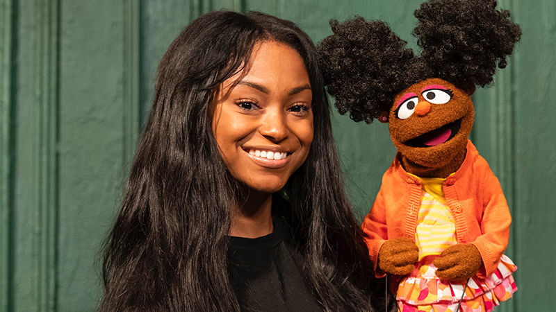 Image of puppeteer with the puppet Gabrielle from Sesame Street