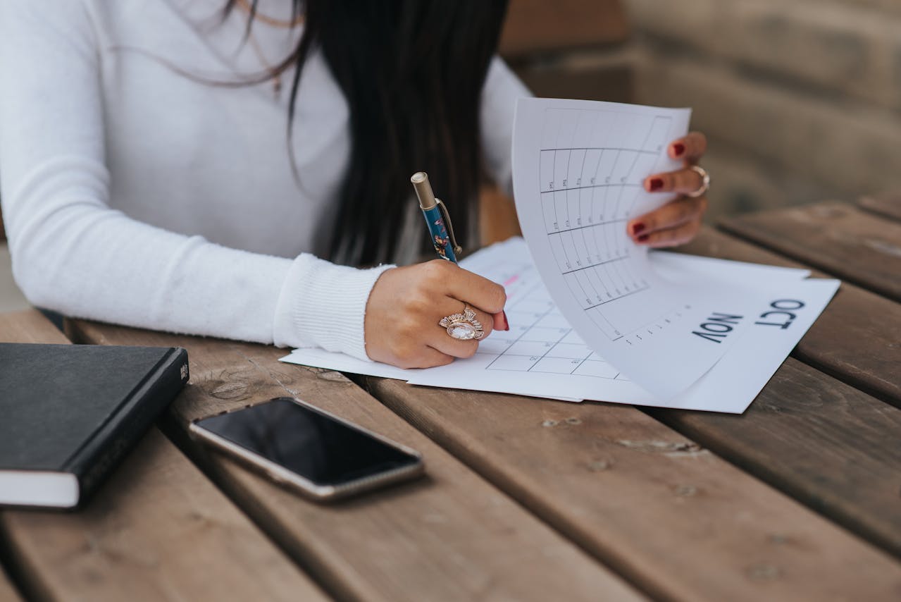 image of a woman writing at a calendar